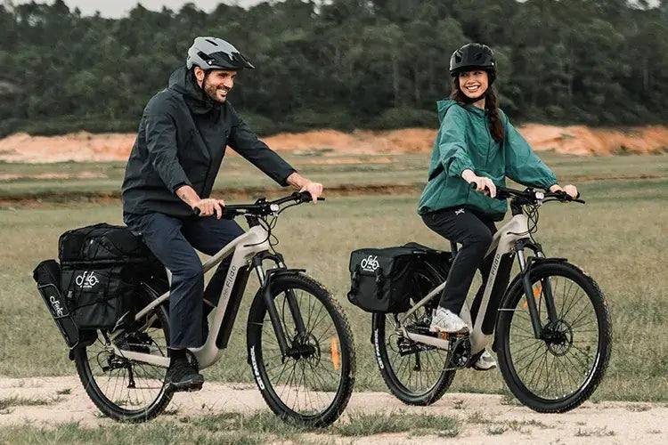 A couple rides a Fiido electric bicycle around town.