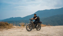 A man rides a Fiido Titan electric bike off-road