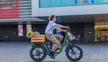 A cyclist speeds through an urban area on her Fiido T1 Pro electric bike.