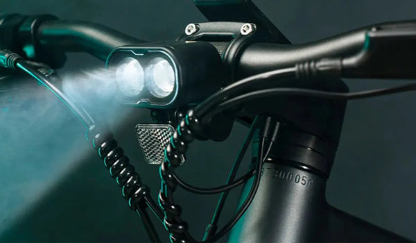 Cyclist traveling Fiido e-bike in the dark and turned on the e-bike's headlight.