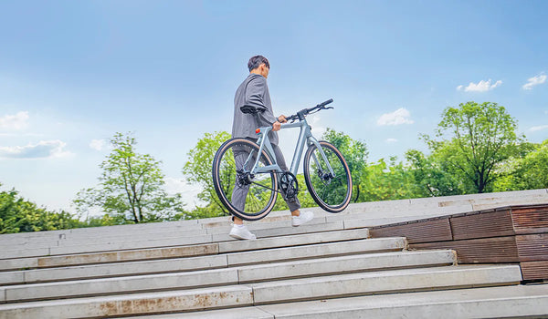 A man climbs the stairs with the Fiido Air with ease.