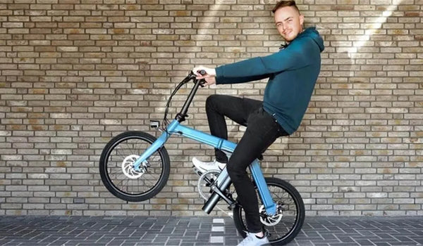 A man is performing difficult movements on a Fiido D11 electric bike.