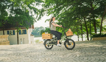 A woman riding the Fiido T3 e-bike on the road