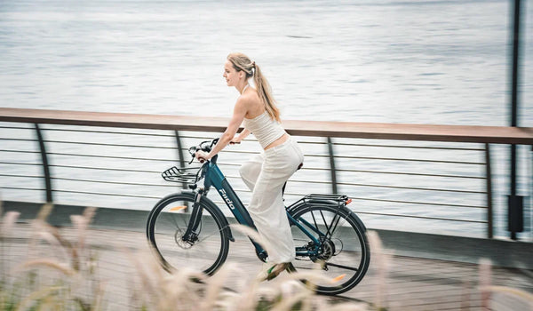 A woman is riding a Fiido C11 Pro urban lightweight electric bicycle on the road.