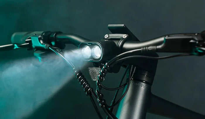The headlight of a Fiido C21 city e-bike is turned on.