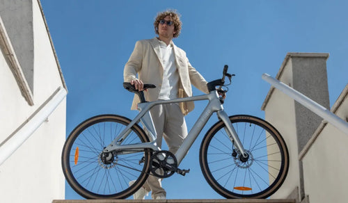 A man riding a Fiido Air carbon fiber electric bike in the city.
