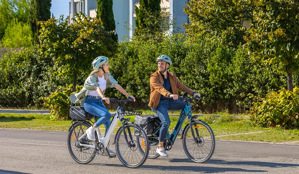 A man and a woman riding Fiido C11 electric bicycles for a ride