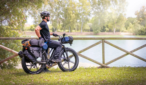 A man is riding a Fiido Titan hunting eBike, preparing for a hunt.