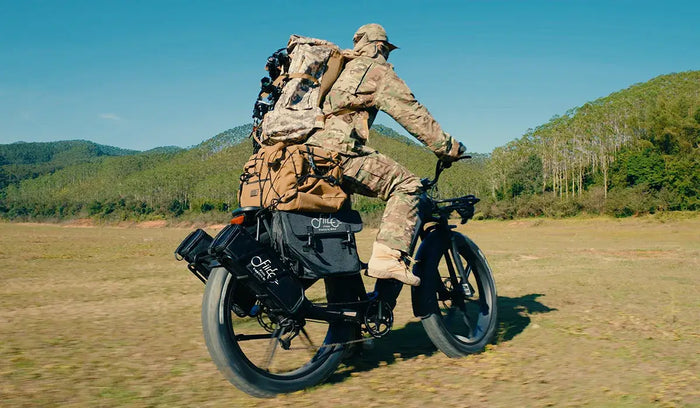 A man prepares to hunt in the wilderness on a Fiido Titan electric bicycle.