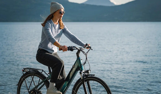 A woman riding a Fiido C11 Pro by the lake.