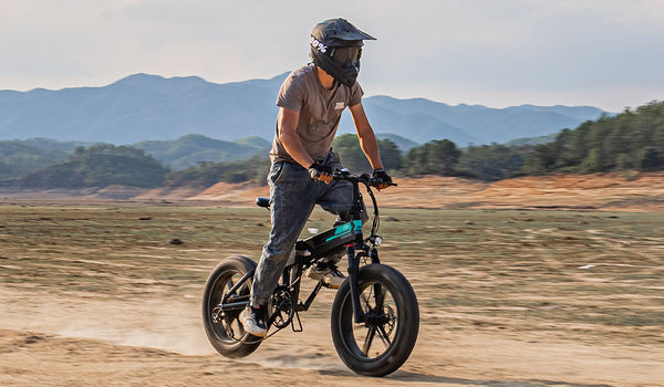 Man riding electric bike on sand